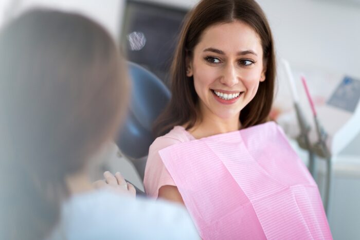 woman in dental chair at dentist, first preventive dental visit